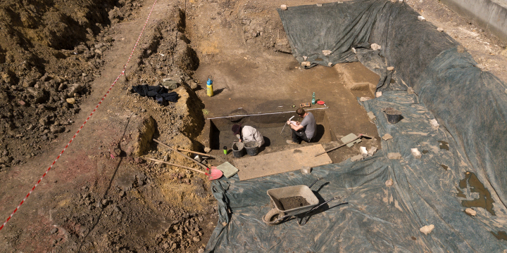 Grabung mit zwei Archäologen und Werkzeug