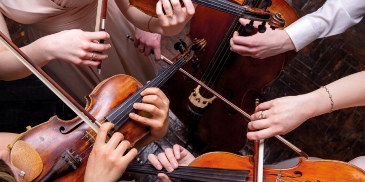 Eine Aufnahme von oben, die Mitglieder der Jenaer Philharmonie und hauptsächlich ihre Instrumente zeigt