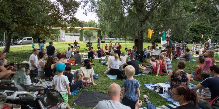 Menschen sitzen auf einer Wiese und schauen den Künstlern zu  ©JenaKultur, T. Peißker